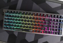 RGB backlit Republic of Gamers keyboard on a dark geometric mousepad.