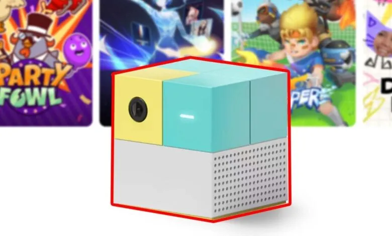 Colorful cube-shaped projector with game cards in the background.