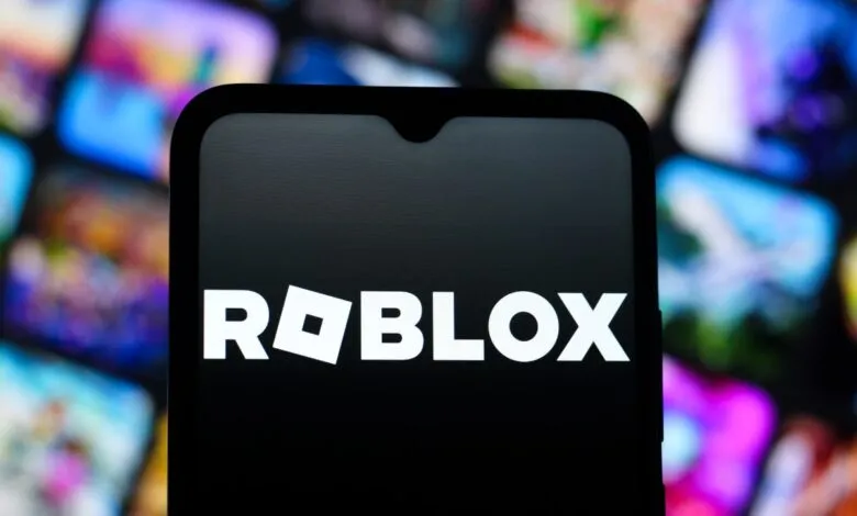 Roblox logo displayed on a smartphone screen with blurred background.