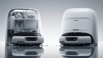Two Romo robots, one transparent showing internal components, on a reflective surface.