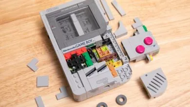 LEGO Nintendo Game Boy partially disassembled on a wooden surface.