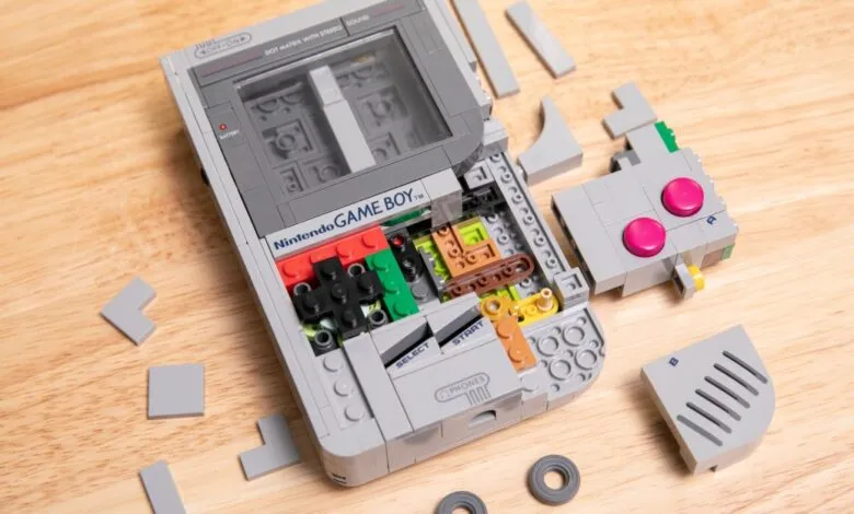 LEGO Nintendo Game Boy partially disassembled on a wooden surface.