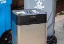 Clear Drop automatic trash can with blue, gray, and green recycling bins.