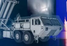 Missile launcher truck with missiles and launch imagery in the background.