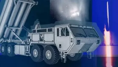Missile launcher truck with missiles and launch imagery in the background.
