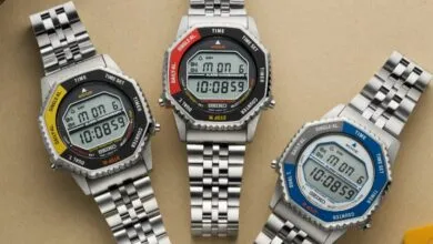 Three Seiko digital watches with different colored bezels on a neutral background.