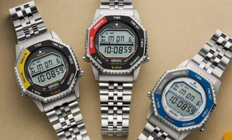 Three Seiko digital watches with different colored bezels on a neutral background.