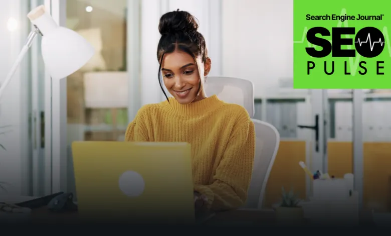 Woman in yellow sweater smiles while working on a yellow laptop.