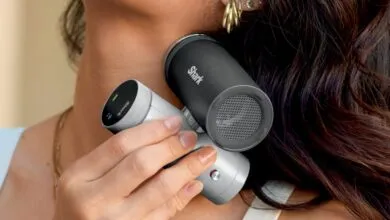 Woman holding Shark Beauty FlexStyle Air Styling & Drying System.