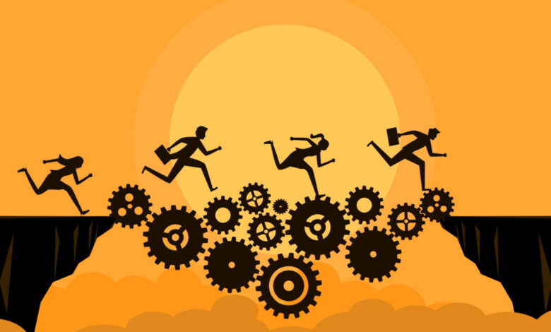 Silhouetted figures running across gears over a chasm, orange background.