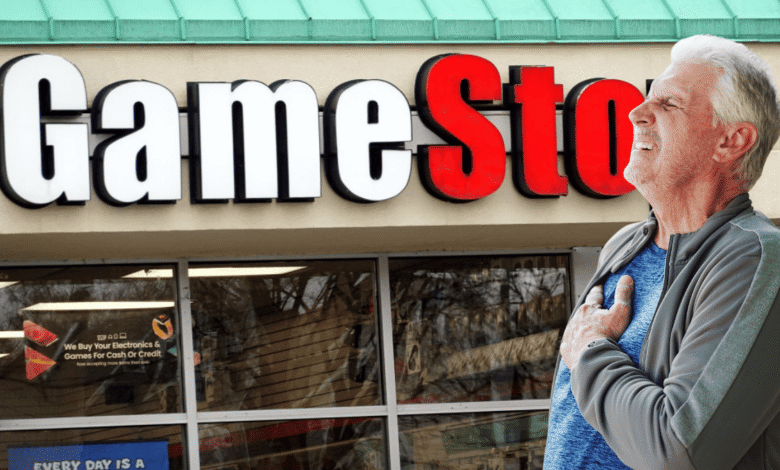 Man clutches chest outside GameStop, possibly experiencing pain.