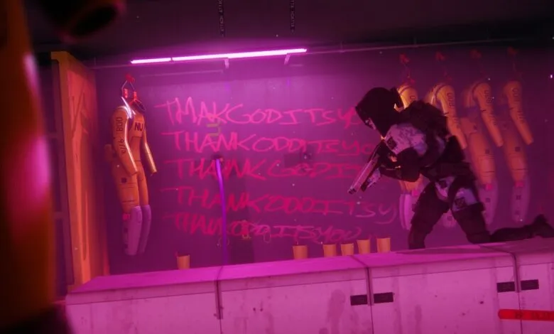 Figure in tactical gear kneels in room with hazmat suits and graffiti.