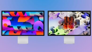 Two studio displays with colorful abstract wallpapers on a gradient background.