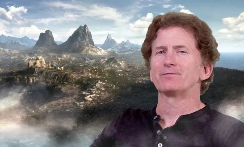 Todd Howard smiles against a fantasy landscape backdrop.