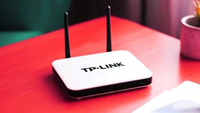 TP-Link router on a red surface with two antennas.