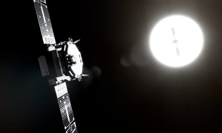 Satellite with solar panels against a bright light source in space.