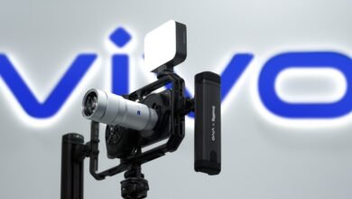 Vivo phone in camera cage with lens, light, and battery pack.