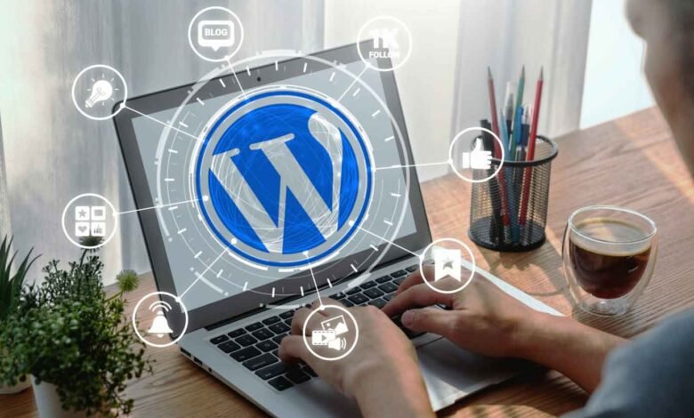 Person typing on laptop with WordPress logo and social media icons.