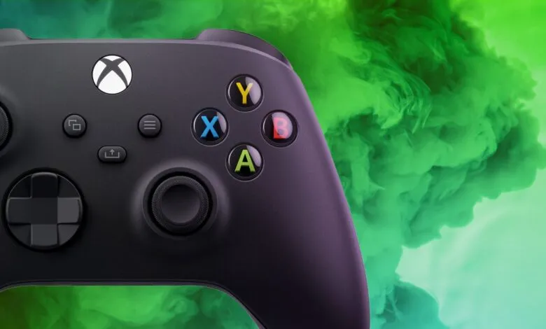 Close-up of a black Xbox controller against a green smoke background.