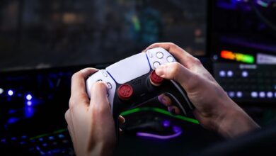 Hands hold a PlayStation 5 controller while gaming.