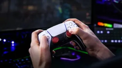 Hands hold a PlayStation 5 controller while gaming.