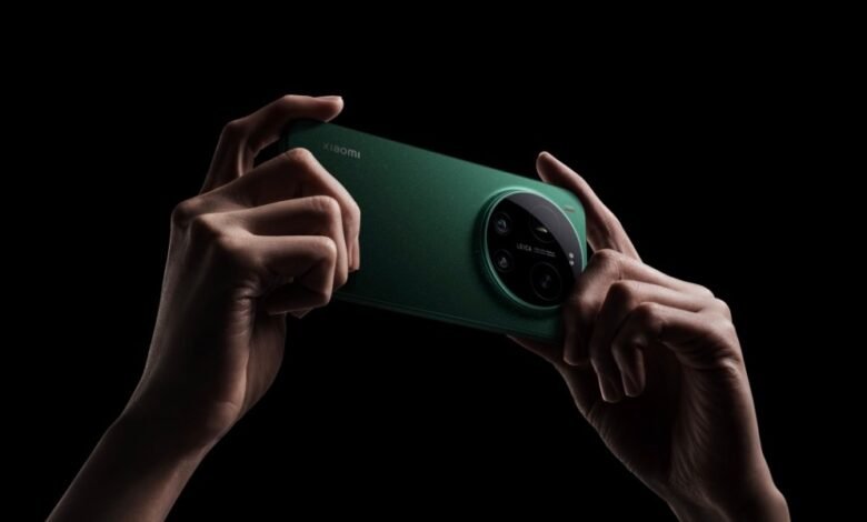 Hands holding a green Xiaomi smartphone with Leica camera on a black background.