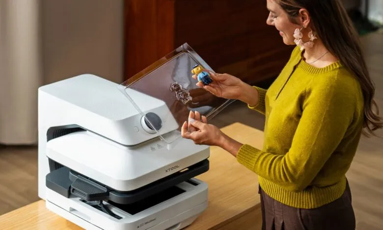 Woman using xTool WonderPress to transfer design onto a small plush toy.