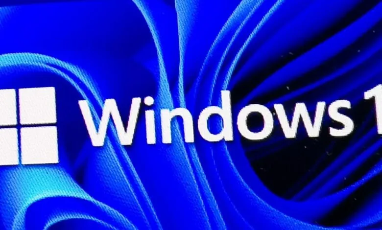 Windows 11 logo with blue abstract background.