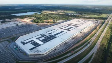 Aerial view of Tesla's Gigafactory Texas, showing its massive size and solar panels.