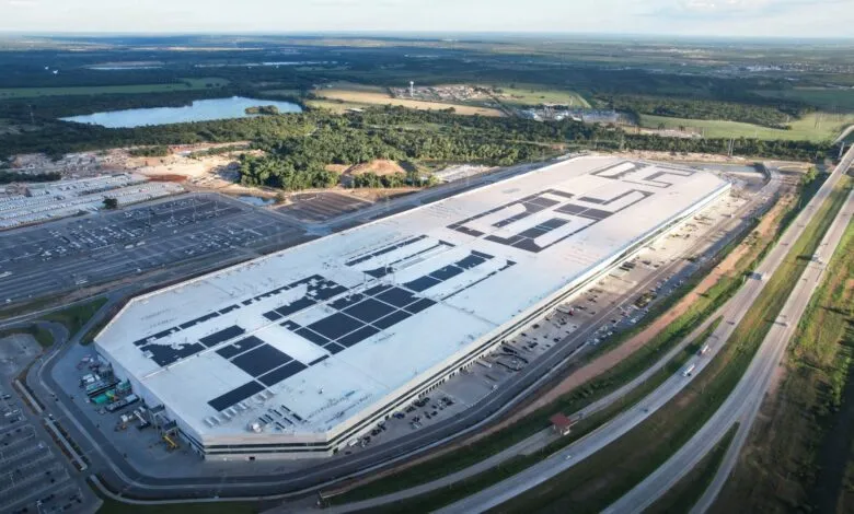 Aerial view of Tesla's Gigafactory Texas, showing its massive size and solar panels.