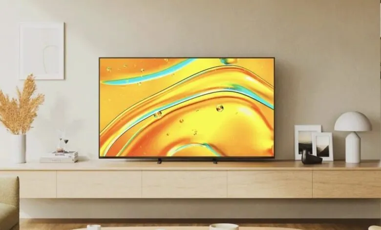 Modern living room with a flat-screen TV displaying vibrant abstract art.