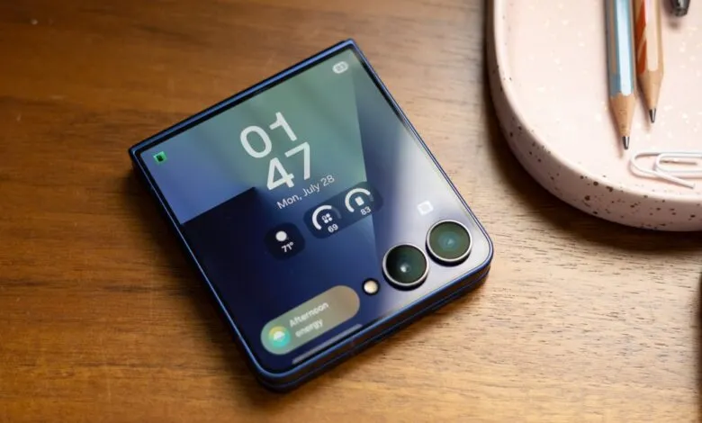 Samsung Galaxy Z Flip phone displaying time and widgets on its cover screen.