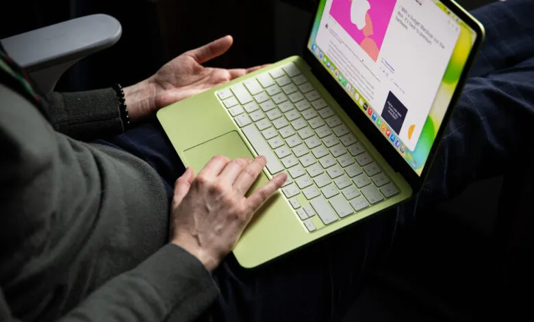Lime green MacBook Air being used on a person's lap while traveling.