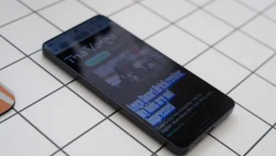 Smartphone displaying 'The Verge' article about Lego Smart Brick review.