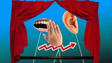 Surreal image: mouth, ear, hand, and rising graph on stage.