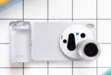 Overhead shot of a silver Vivo smartphone with a large camera module on a tiled surface.