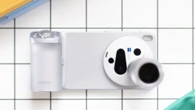 Overhead shot of a silver Vivo smartphone with a large camera module on a tiled surface.