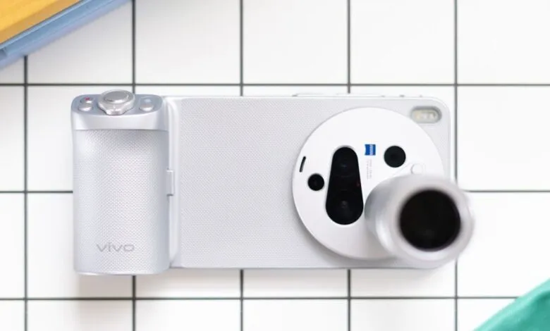 Overhead shot of a silver Vivo smartphone with a large camera module on a tiled surface.