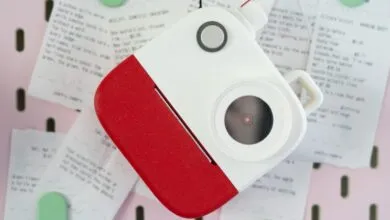 Poetry Camera close-up on pink pegboard with receipts and notes.