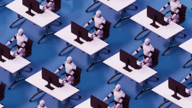 Rows of humanoid robots working at desks with computers in an office setting.