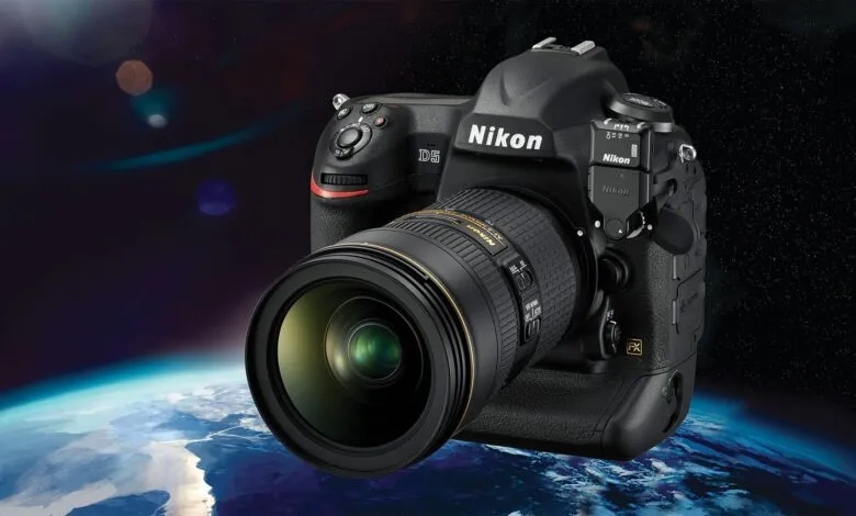 Nikon D5 camera with lens, against a backdrop of Earth and stars.
