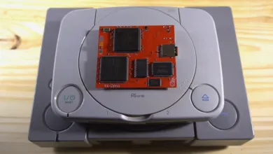 PSOne console with a red circuit board on top, showcasing electronics.