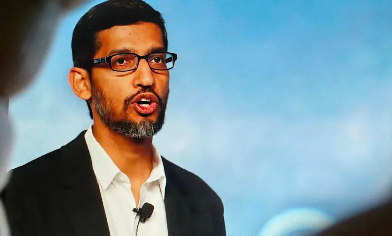 Sundar Pichai, CEO of Google, speaking at a conference with a blue background.