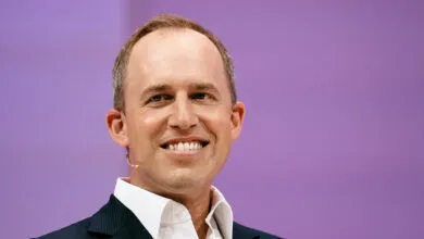 Bret Taylor, Salesforce Co-CEO, smiles against a purple backdrop.