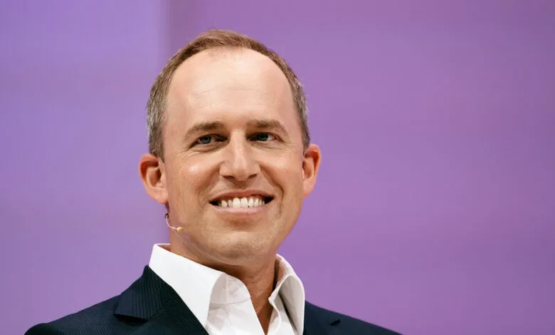 Bret Taylor, Salesforce Co-CEO, smiles against a purple backdrop.
