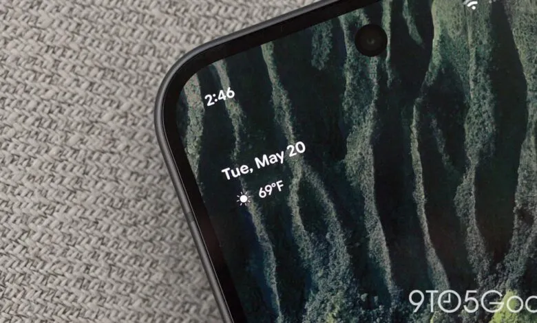 Close-up of a phone screen displaying the date, time, and weather.