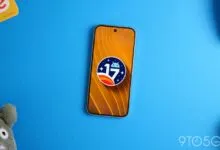 Android 17 logo on a smartphone screen against a blue background.
