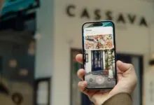 Person using iPhone to view restaurant info via visual search.