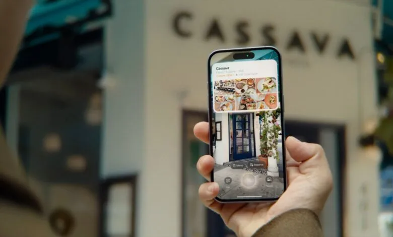 Person using iPhone to view restaurant info via visual search.
