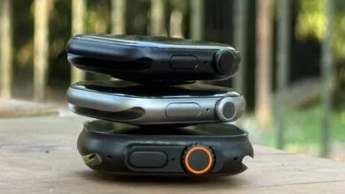 Three Apple Watches stacked on top of each other, showing different models.